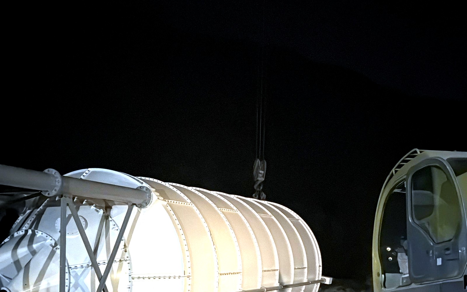 Tall cylindrical silo with two visible conical discharge outlets
