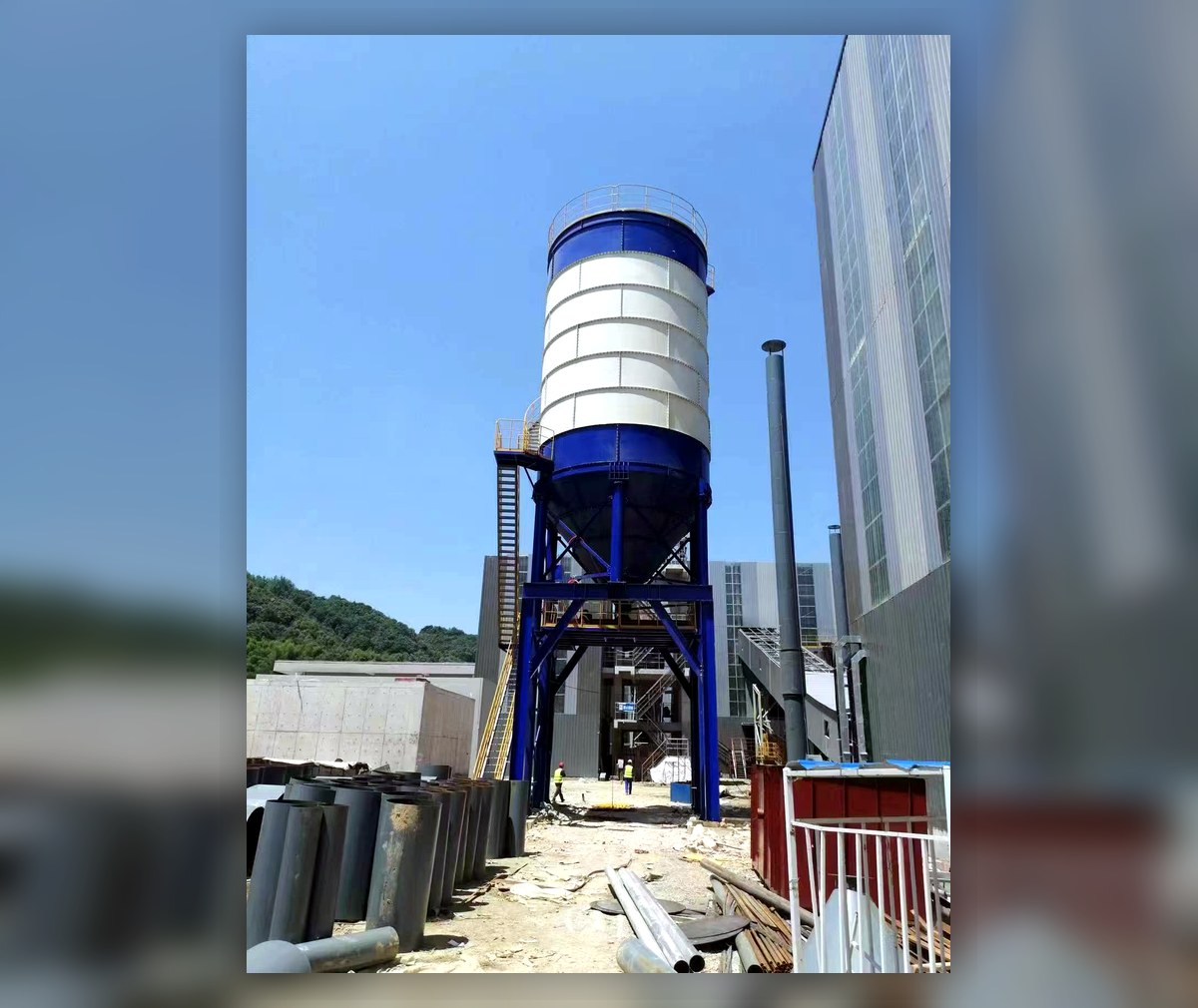 Elevated silo on a tall steel frame with an open passage below