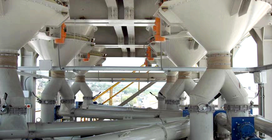 Bin activators installed below dry bulk material hoppers